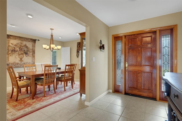 entryway featuring light tile patterned flooring and an inviting chandelier