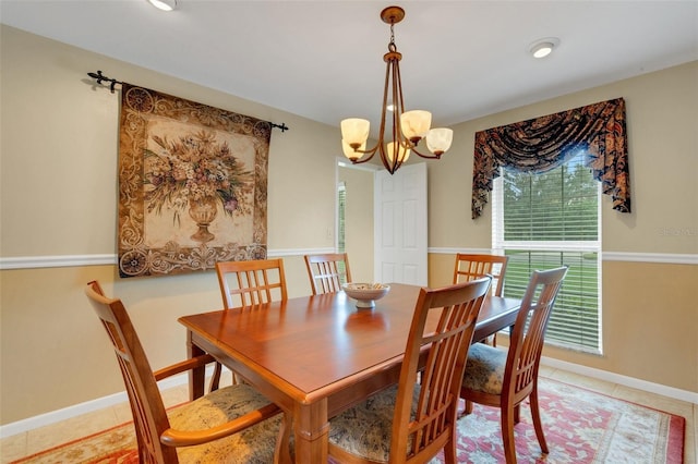 tiled dining room featuring an inviting chandelier and a wealth of natural light