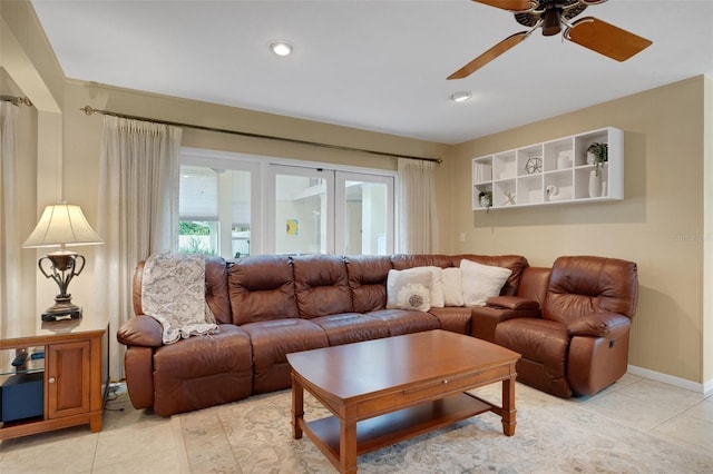 living room with ceiling fan and light tile patterned flooring