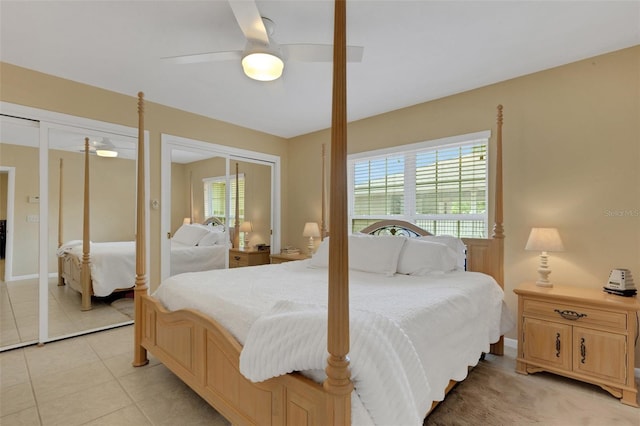 tiled bedroom with ceiling fan and multiple windows