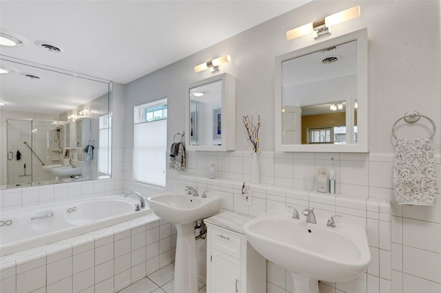 bathroom with double sink, tile patterned floors, and shower with separate bathtub