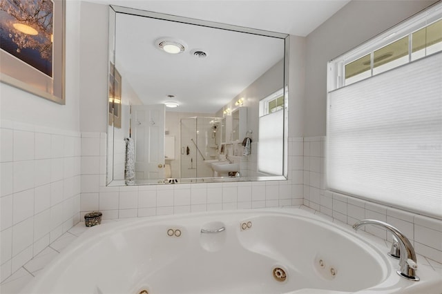 bathroom featuring shower with separate bathtub