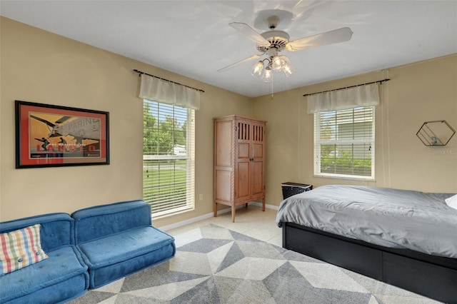 bedroom with ceiling fan and light colored carpet