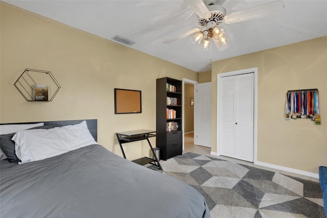 bedroom featuring light carpet, a closet, and ceiling fan