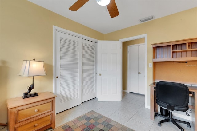 tiled office space featuring ceiling fan