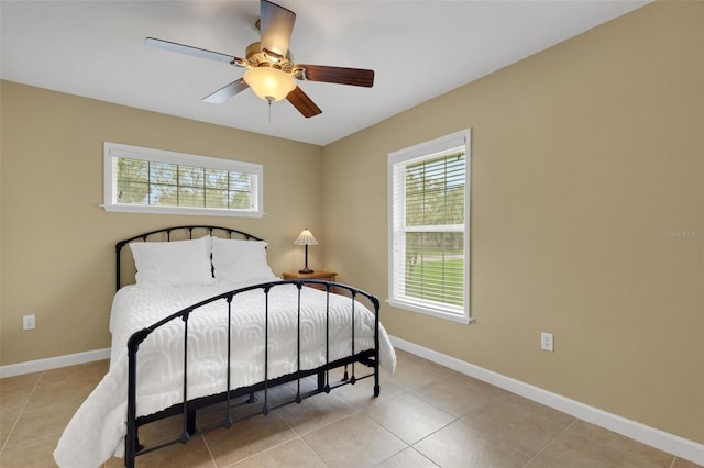 bedroom with ceiling fan and light tile patterned flooring