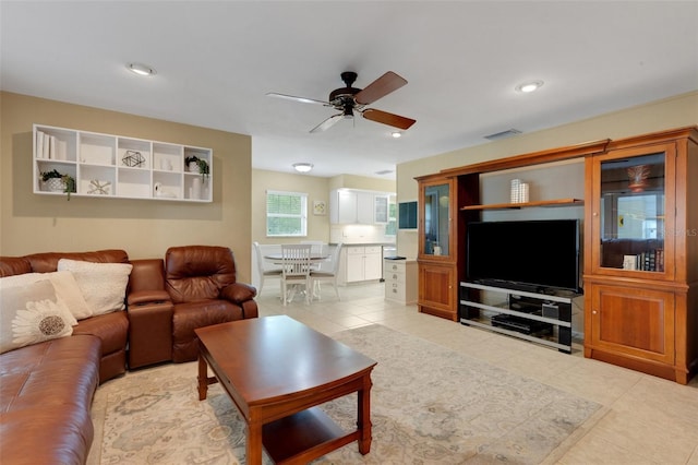 living room with light tile patterned floors and ceiling fan