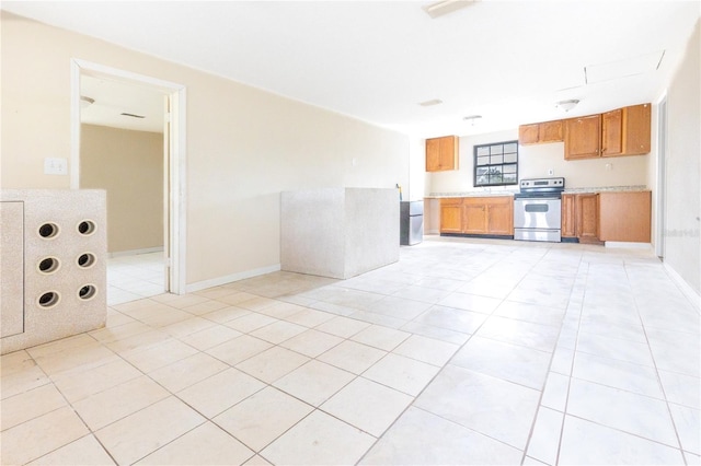 kitchen with light tile patterned floors and stainless steel range with electric cooktop