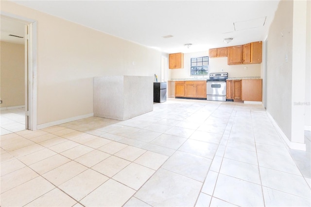 kitchen featuring electric stove and light tile patterned flooring