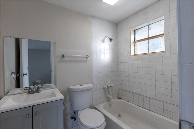 full bathroom with toilet, vanity, and tiled shower / bath combo