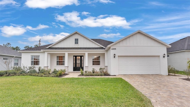 view of front facade with a garage and a front lawn