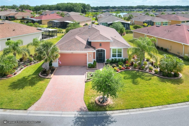 view of front of house featuring a front lawn and a garage