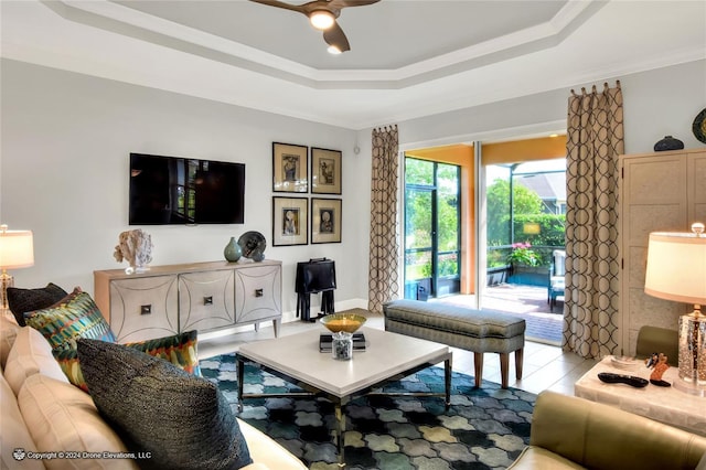 living room featuring ceiling fan, crown molding, and a raised ceiling