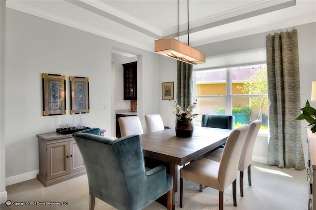 carpeted dining space featuring crown molding