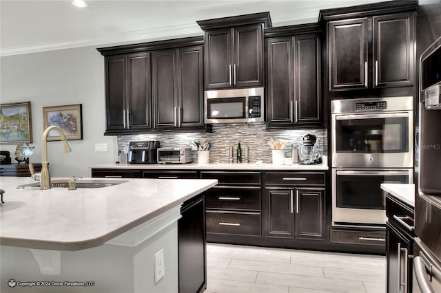 kitchen with stainless steel appliances, tasteful backsplash, dark brown cabinets, ornamental molding, and sink