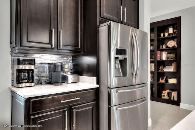 kitchen with backsplash, dark brown cabinetry, and stainless steel fridge with ice dispenser