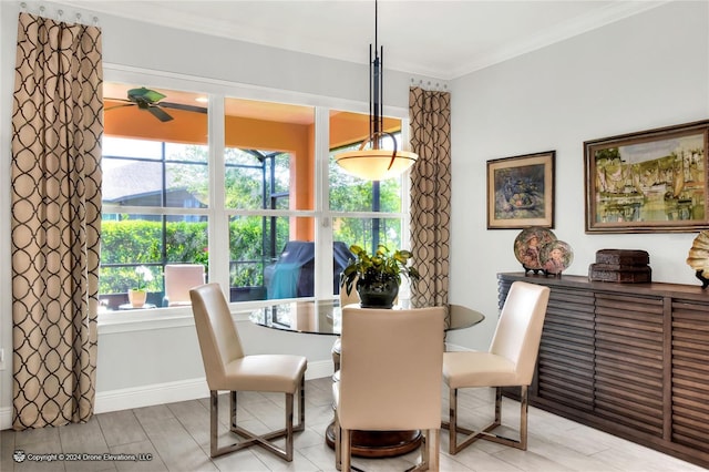 dining room with ceiling fan and crown molding