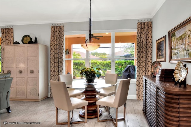 dining room with crown molding and light hardwood / wood-style floors