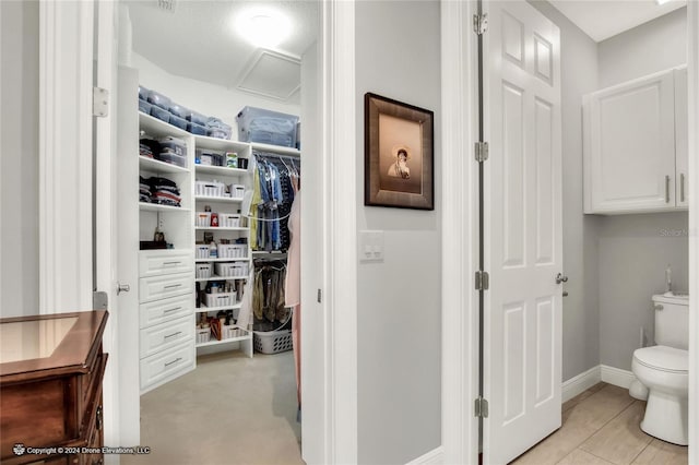 spacious closet with light tile patterned floors