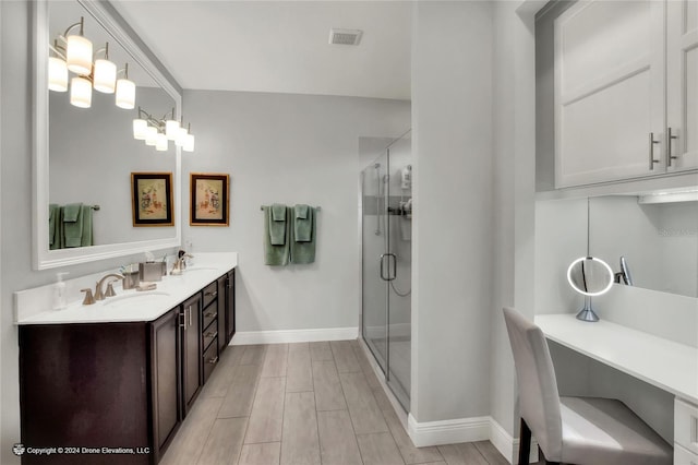 bathroom featuring walk in shower and vanity