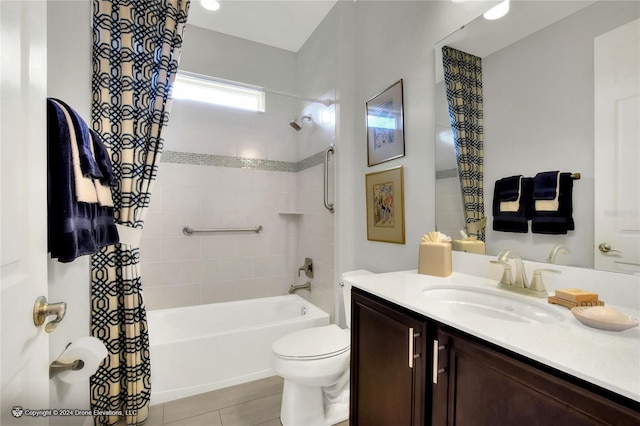 full bathroom featuring toilet, tile patterned flooring, tiled shower / bath combo, and vanity