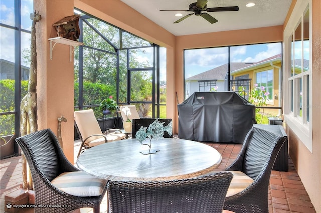 sunroom with ceiling fan and plenty of natural light