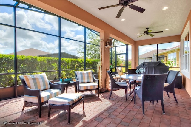 sunroom / solarium featuring ceiling fan