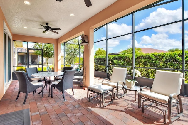 sunroom / solarium featuring ceiling fan and plenty of natural light