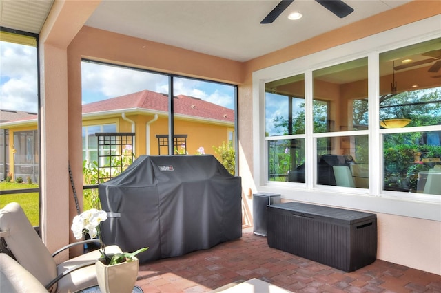 sunroom / solarium featuring ceiling fan and radiator