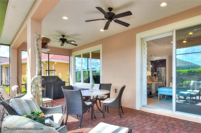 sunroom / solarium featuring ceiling fan