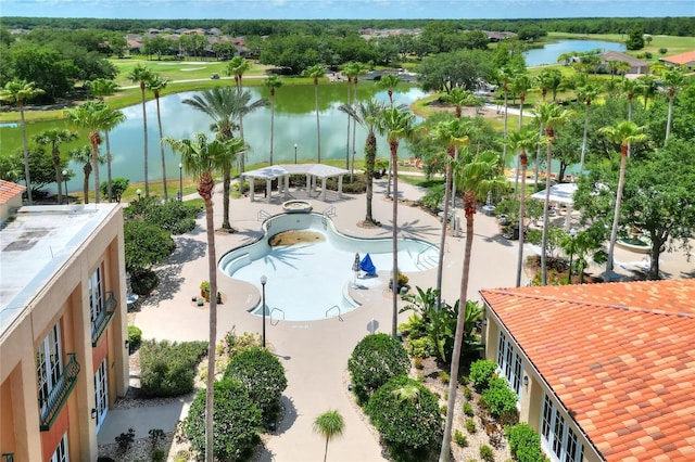 view of pool featuring a water view and a patio