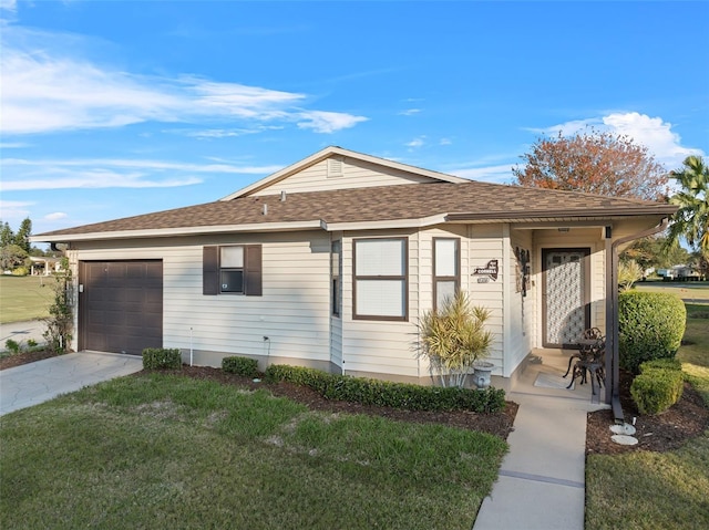 ranch-style home with a front lawn and a garage