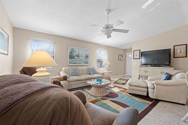 tiled living room featuring ceiling fan, plenty of natural light, a textured ceiling, and lofted ceiling