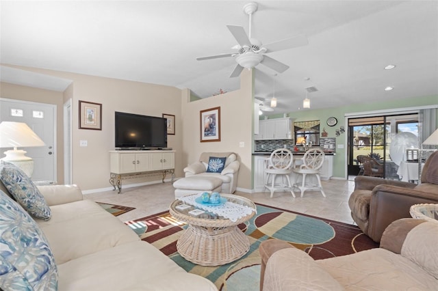 tiled living room featuring ceiling fan and lofted ceiling