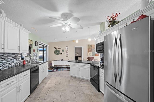 kitchen featuring ceiling fan, backsplash, vaulted ceiling, black appliances, and white cabinetry