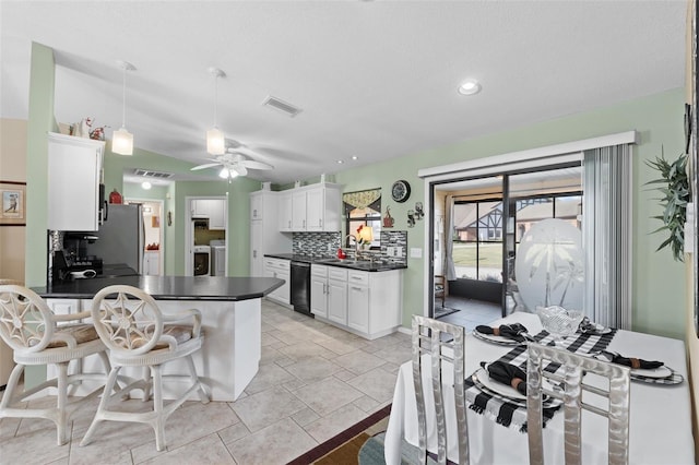 kitchen with dishwasher, white cabinetry, tasteful backsplash, stainless steel fridge, and ceiling fan