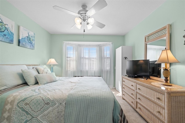 bedroom with light carpet and ceiling fan