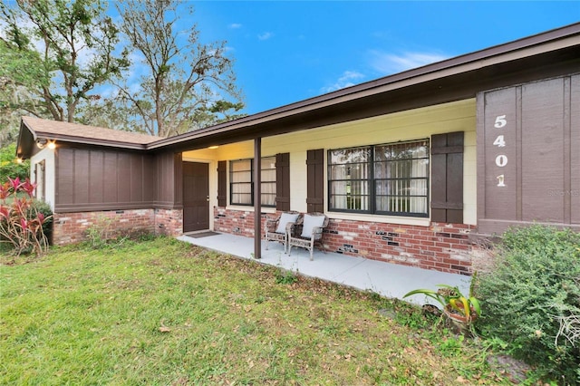 rear view of property with a yard