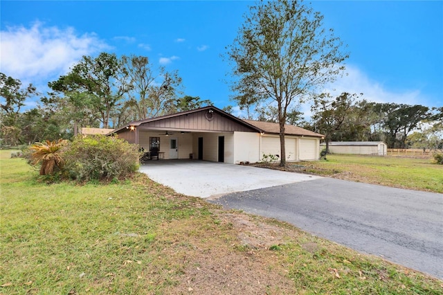 view of home's exterior featuring a garage, a carport, and a lawn