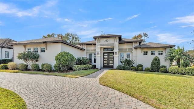 view of front facade with a front lawn and french doors