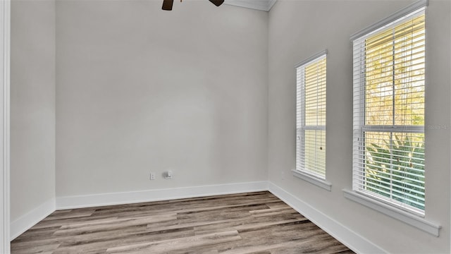 empty room with hardwood / wood-style floors and ceiling fan