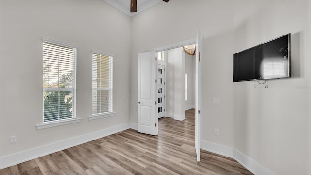 unfurnished room with ceiling fan and light wood-type flooring