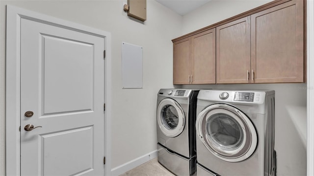 laundry area with cabinets and washing machine and clothes dryer