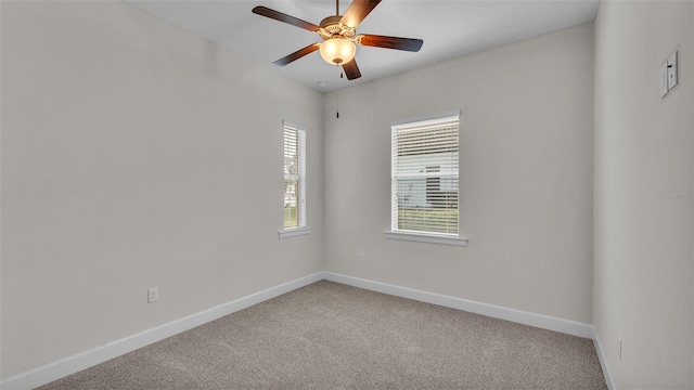 carpeted spare room with ceiling fan