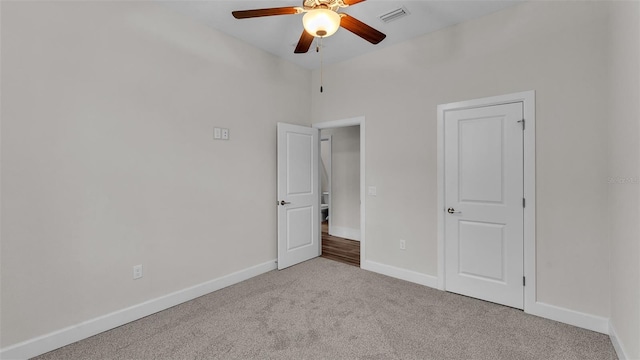 unfurnished bedroom featuring light carpet and ceiling fan