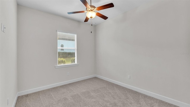 spare room featuring ceiling fan and light colored carpet