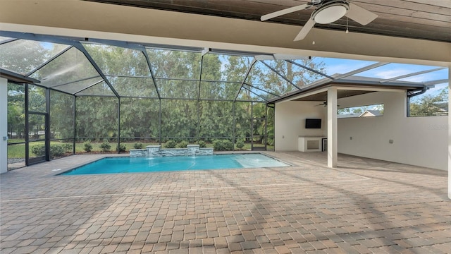 view of pool with pool water feature, ceiling fan, glass enclosure, and a patio