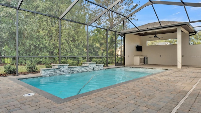 view of pool featuring pool water feature, ceiling fan, a lanai, and a patio area