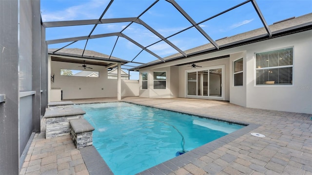 view of swimming pool featuring pool water feature, ceiling fan, a lanai, and a patio area