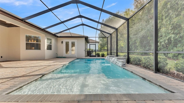 view of swimming pool featuring pool water feature, a patio area, glass enclosure, and french doors